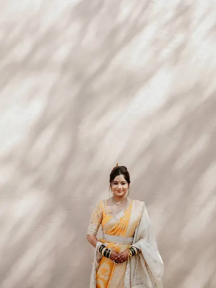 A simple, elegant portrait. The focus is on the bride's happy expression and the beautifully draped Nauvari.