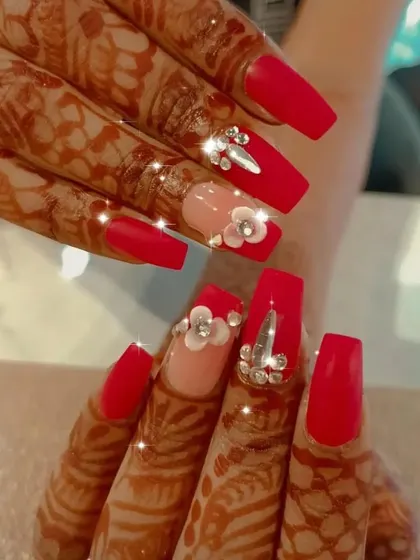 The perfect bridal nails to complement henna, this set features matte red nails, 3D flowers, and stunning crystal embellishments.
