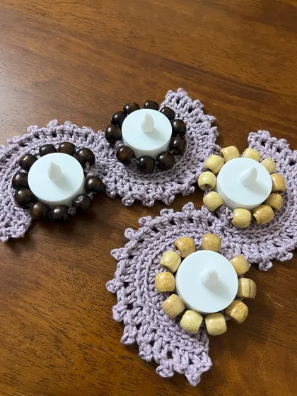 A set of individual tealight holders, some with dark beads and some with light ones. You can mix and match these to create your own unique decorative arrangement.