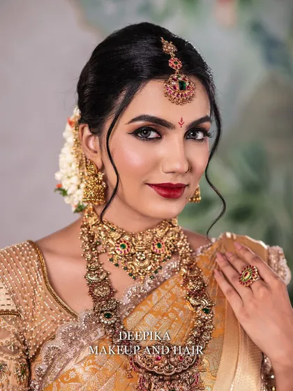 A close-up portrait that captures the flawless finish of the makeup. The skin looks radiant, and the red lip is perfectly applied.