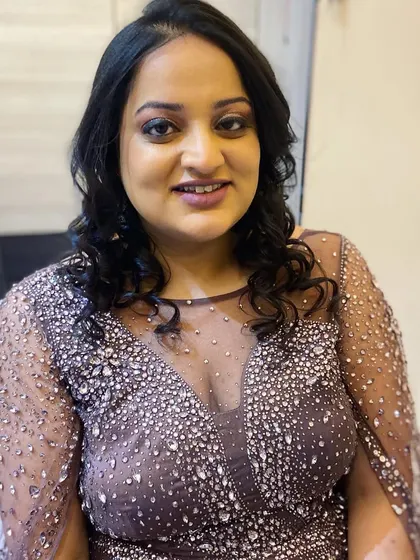 A smiling portrait of the client, looking beautiful and ready for the party.