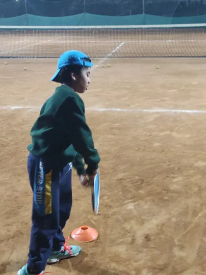 Even our youngest players in the U-6 and U-8 groups learn proper form from day one. This young athlete is getting ready to execute a forehand during a night session.