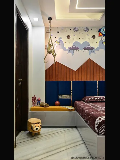 A closer look at the details in this fun kid's bedroom. The design includes a cushioned bench for seating and storage, along with a playful monkey lamp that adds a touch of whimsy.