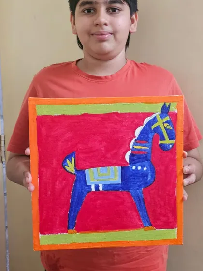 A student with his beautiful recreation of a Jamini Roy folk art painting, showcasing the bold lines and colors characteristic of the master's style.