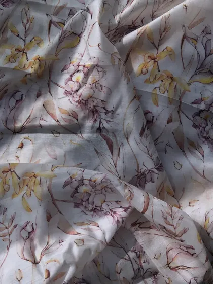 A close-up of our printed muslin fabric, showcasing its delicate watercolor floral print and breathable texture.