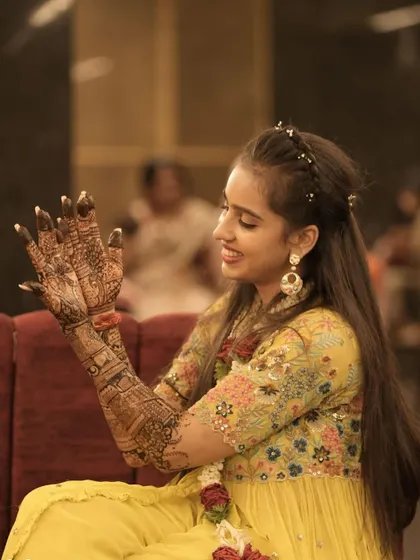A candid moment of our pretty bride admiring her hands, covered in detailed patterns and stories. This is the magic we aim to create for every bride.