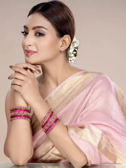 Showcasing a set of pink bangles, this image maintains a consistent, elegant theme perfect for a cohesive catalogue layout.