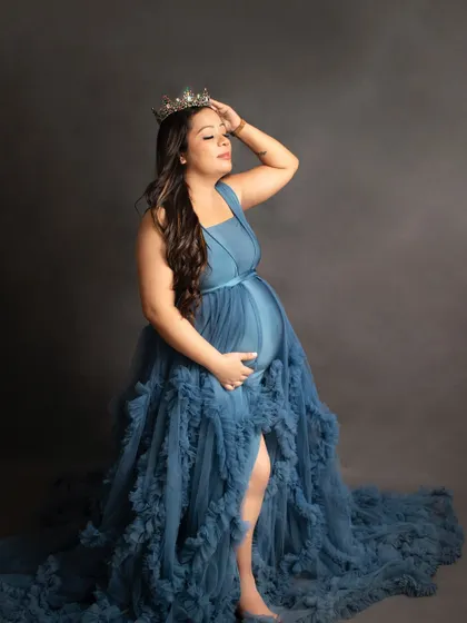 A powerful solo portrait of a mother-to-be wearing a crown with her blue gown. This shot is all about celebrating the queen that you are.