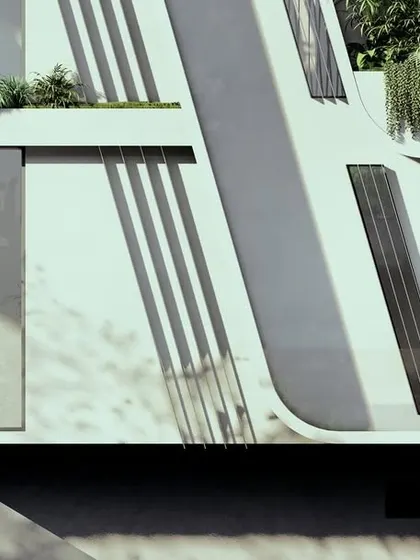 A detail of the sloping facade at Moira Homes. The angled concrete forms are not just an aesthetic choice; they are a functional response to the climate, providing shade and creating protected outdoor spaces.