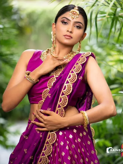 A classic pose showcasing the elegance of our purple brocade half saree, available for rent for your special occasions.