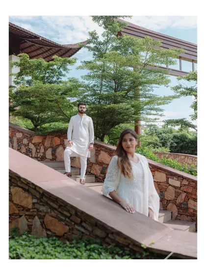 A stylishly composed pre-wedding shot, with the couple posing on a stone staircase, creating a sense of depth and perspective.