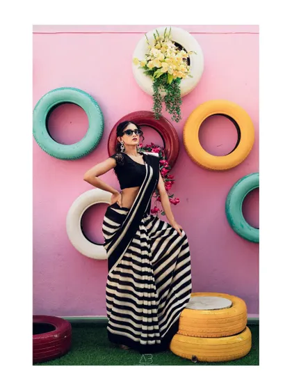 This image captures the playful attitude of the shoot, showing how traditional wear can be styled for a modern, rebellious look. It’s about breaking stereotypes one pleat at a time.