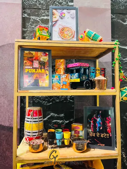 A vibrant Punjabi-themed decor shelf, complete with a miniature truck, dhol, and colourful lassi glasses to set the mood.