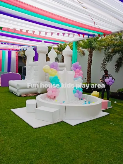 We can customize our white play areas with decor to match your party's theme, like the pastel balloon garland on this ball pit and bouncy castle.