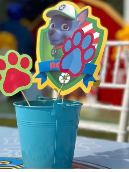 It's all in the details. This custom Paw Patrol centerpiece featuring Rocky adds a personalized touch to the party tables.