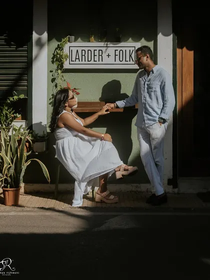 A candid moment of connection in the Latin Quarters of Panjim. The strong shadows and bright sunlight create a dramatic effect, highlighting the couple as they share a quiet moment.
