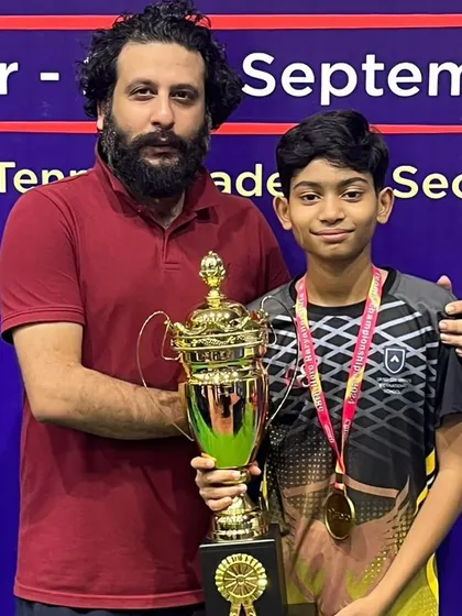 Celebrating another one of our champions holding his trophy at the state championship. Each win is a result of a personalized training plan and the player's dedication to the sport.