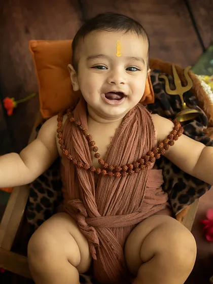 A happy little Shiv bhakt. This older baby's joyful expression during our Shiva-themed milestone shoot is absolutely infectious. Om Namah Shivaya!