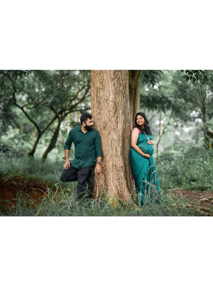 A candid moment between a couple during their outdoor maternity session. The natural forest light and their relaxed interaction are central to our photography style, capturing the authentic connection between partners.