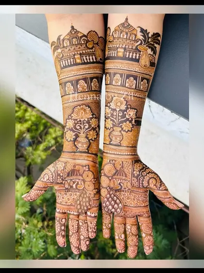 A stunning bridal design featuring pichwai-inspired elements like lotus vases and peacocks, combined with traditional architecture. The result is a unique and artistic look.