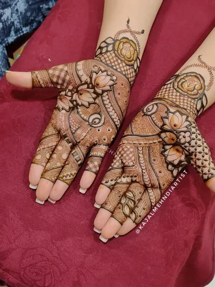 A gorgeous blend of floral elements for the modern bride. This design features delicate lotus flowers on the fingers and bold roses at the wrist, creating a beautiful garden on the hands.