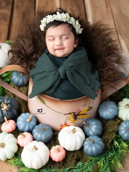 A happy, smiling pumpkin in a watering can. This setup is so unique and adorable.