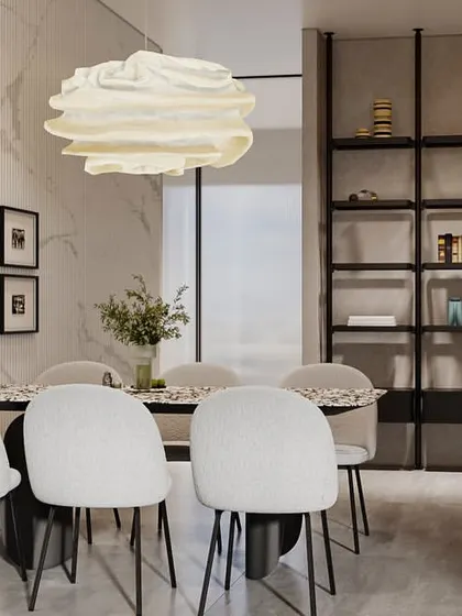 A dining area where minimalism meets texture. The space features a gallery wall of framed prints, a sculptural pendant light, and a large shelving unit, all set against a backdrop of marble and fluted wall panels.