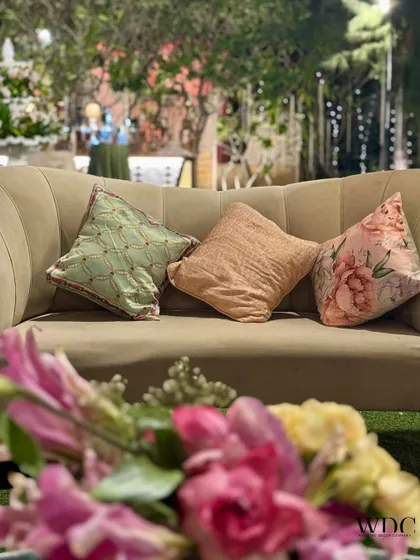 A close-up of the comfortable seating, with custom-printed and textured cushions in pastel shades, adding to the serene and grand theme.