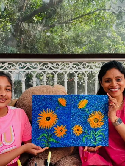 A mother and daughter proudly present their collaborative sunflower painting. A beautiful piece of art made from a beautiful memory.