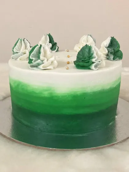 Another view of the green ombré swirl cake, showing the smooth transition of colors. This design can be customized with any color palette to match your event theme.