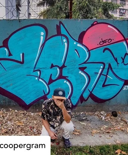 Posing with a finished piece in Mumbai. This shot, also by Martha Cooper, captures the artist and the art in its urban environment.