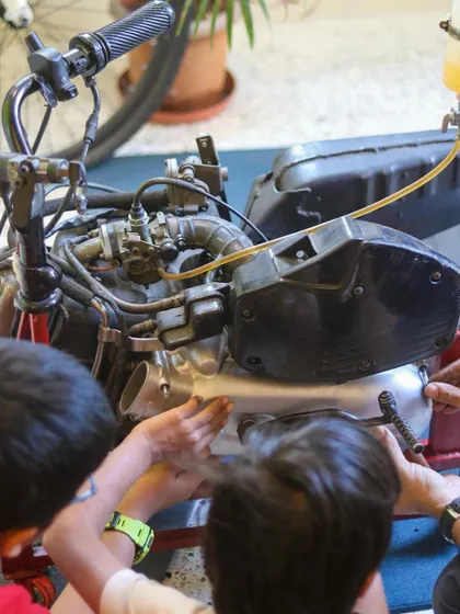 Students get up close with a motorcycle engine, learning how to identify different parts and understand their functions. This is a unique and exciting learning experience.