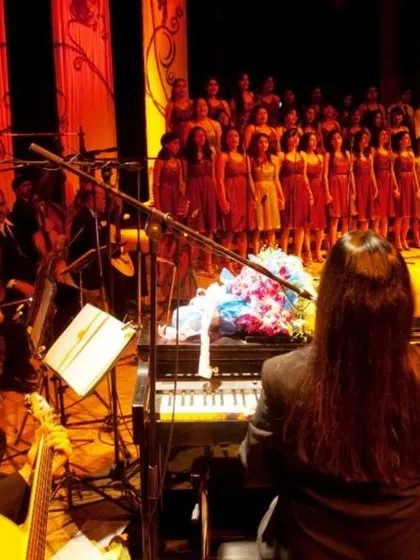 A live concert setup for a corporate function, featuring a pianist, orchestra, and choir. I handle all technical aspects, including sound engineering and stage management, for musical performances.