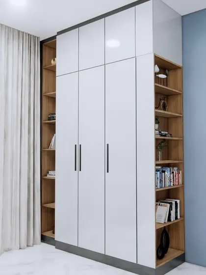 A wardrobe design that maximizes storage with open bookshelves on both sides of the main closet.