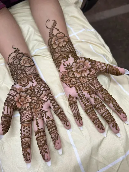 This design features lush floral patterns that flow from the wrist to the fingertips. The use of negative space makes the flowers pop, creating a beautiful 3D effect.