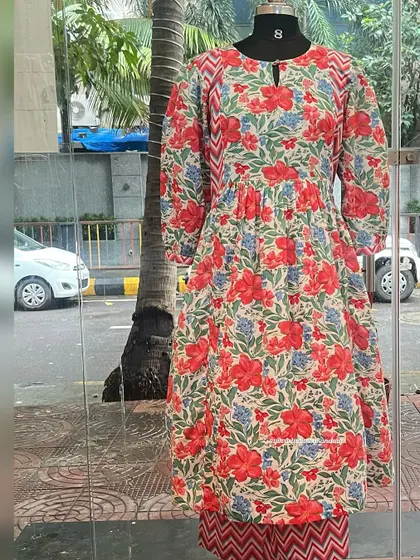 A mannequin display of our vibrant floral and chevron print kurta-pant set, ready to bring joy to your festive season.