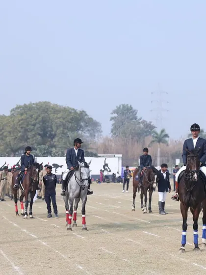 Our riders participating in a parade during a school sports event, demonstrating their skills and discipline to the community.