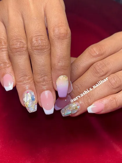 This set combines multiple techniques for a unique bridal look. It features classic French tips alongside a purple ombré nail and accent nails with shattered glass and gold foil details.