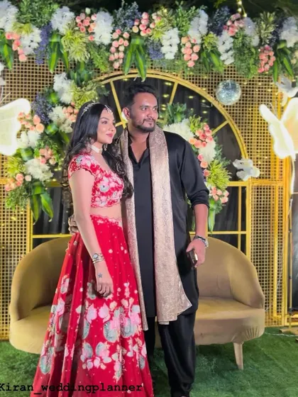 A duplicate of image 19, showing the modern and chic Sangeet decor with a gold grid, florals, and butterfly lights.