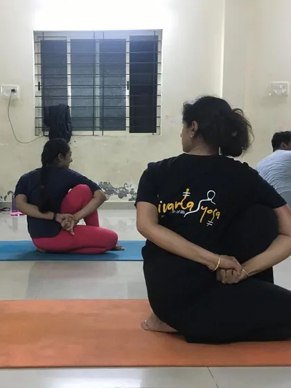 A view of my students in a seated spinal twist. This asana is great for improving digestion and releasing tension from the back and shoulders.