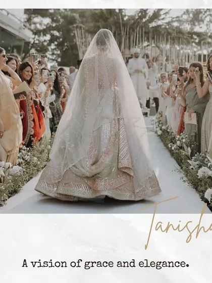 The bride's grand entrance, a vision of grace and elegance as she walks down the aisle, with her long veil trailing behind her.