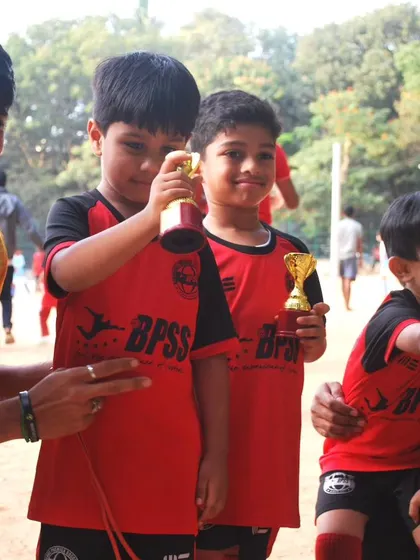 Our coaches sharing a moment of celebration with the young players. The bond between our coaches and players is built on encouragement and mutual respect.