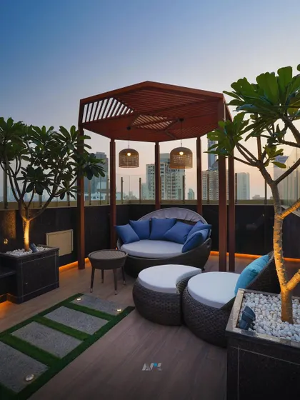 This cozy seating arrangement on the rooftop terrace in Lower Parel is perfect for intimate conversations. The design uses natural materials and comfortable furnishings to create a relaxed, resort-like feel high above the city.