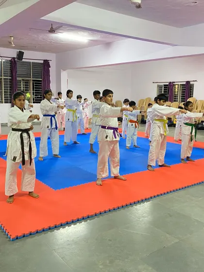 Before sparring, students practice their fundamental stances and punches (Kihon) on the tatami, reinforcing the basics that are the foundation of good Kumite.