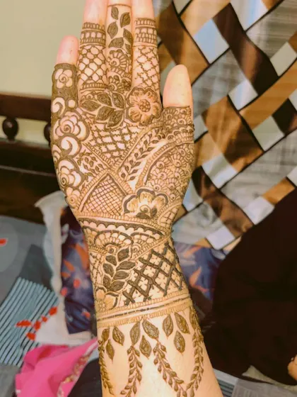 A full-coverage design with beautiful leafy vines climbing down the wrist. The patterns are very dense and detailed, ideal for a traditional bridal mehendi look.