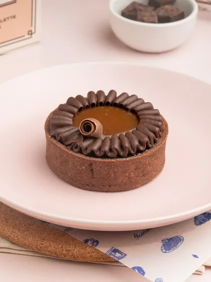 My Dark Chocolate and Sea Salt Caramel Tart is a decadent treat. A crisp chocolate tart shell is filled with gooey caramel and rich chocolate ganache.
