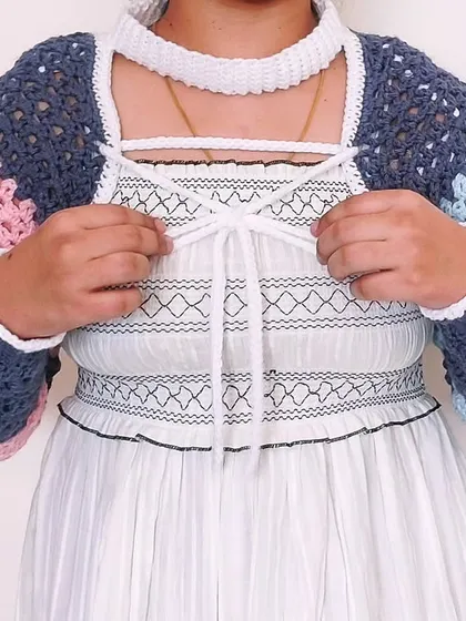 The front of the Gaea Shrug features a corset-style lacing, adding another layer of detail to this intricate design.