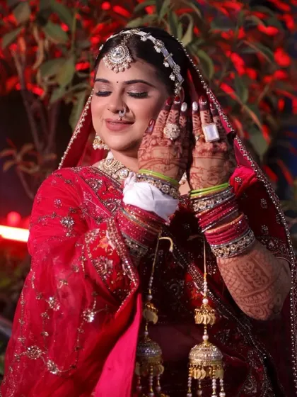 A candid moment capturing the bride's happiness. The makeup is designed to be waterproof and long-lasting, ensuring she looks fresh throughout the long wedding ceremony and celebrations.