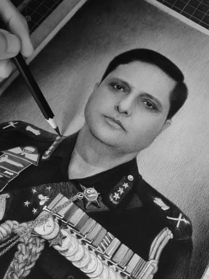 A close-up, in-progress shot of the commander's portrait, showing the careful pencil work.