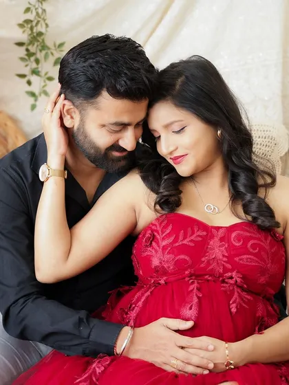 A close and loving portrait of a couple in a cozy, romantic setting. Their gentle embrace and happy expressions say it all.